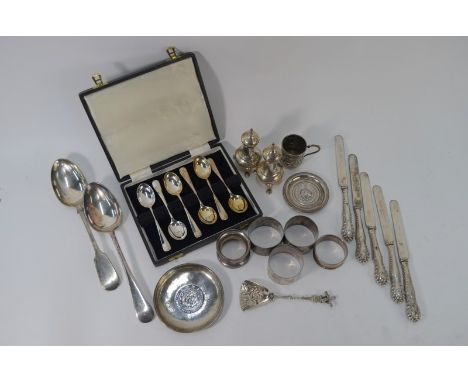 A cased set of six silver Hanoverian rat-tail teaspoons, Sheffield 1975, five various silver napkin rings and a pair of balus