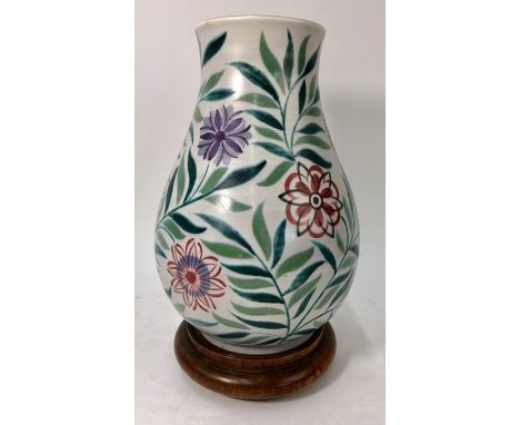 A Poole Pottery baluster vase painted with flower heads and foliage, printed factory stamp 1959-1967, painted X/WL, impressed