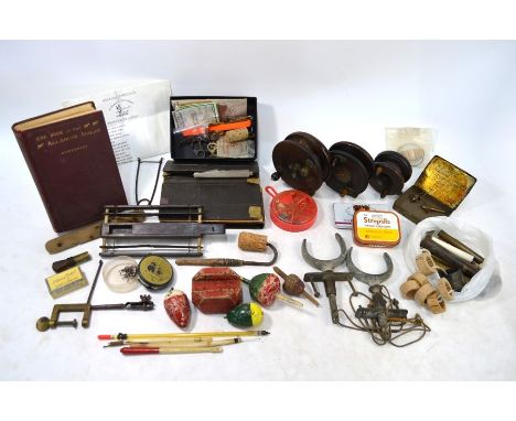 A collection of vintage fishing gear to include; 4½" mahogany and brass reel, 4" and 3" reels (three in total), various coars