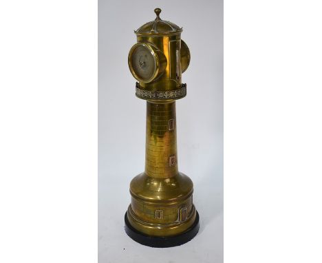 A 19th century French brass table clock/aneroid barometer mounted in the clockwork revolving top of a model lighthouse in the