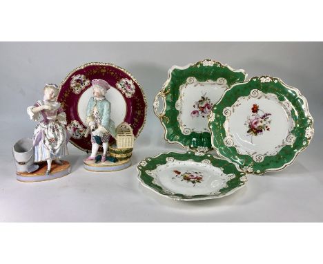 A pair of German porcelain figures depicting a young man opening a wine bottle and a young lady drinking tea, bears underglaz