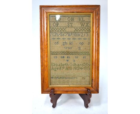 A George IV cross-stitch alphabet sampler by Elizabeth Gilbard Aged 9 1824, 31.5 x 18 cm in glazed maple frame