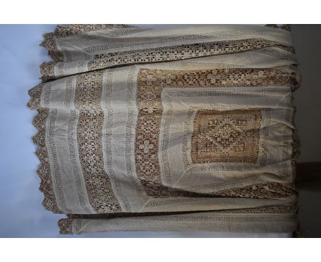 A vintage Portuguese drawn thread-work single bed-cover, backed in pale brown satinised cotton, a cream linen tablecloth with