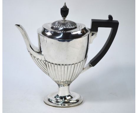 An Edwardian silver half-reeded coffee pot in the Adam manner, on oval stemmed foot, with ebonised urn finial and composite h