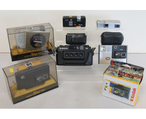 Two sub-miniature spy cameras; Rollei A110, black, and Minolta 16 II, a Nimslo 3D camera, three Kodak disc cameras and anothe