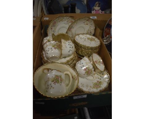 A pretty 20th century part tea service having approximately 33 pieces with gilt edging and blossom design.