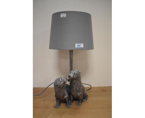 A contemporary table lamp incorporating a pair of otters in silvered finish.&nbsp;
Condition Report
Good used item. No visibl