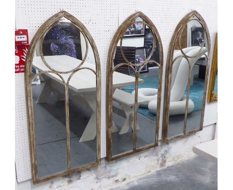 ARCHITECTURAL GARDEN MIRRORS, a set of three, Gothic style in distressed metal frame, 122cm x 56cm. (3)