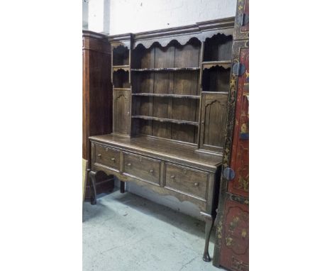 OAK DRESSER, Victorian and later, the shelf and cupboard super structure raised on a base fitted with three deep drawers, cab