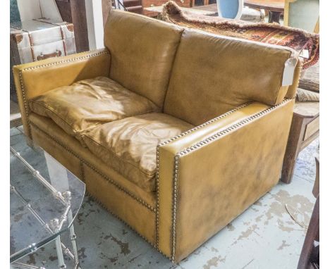 SOFA, two seater, in studded mustard leather with back and seat cushions, 142cm W x 90cm D.