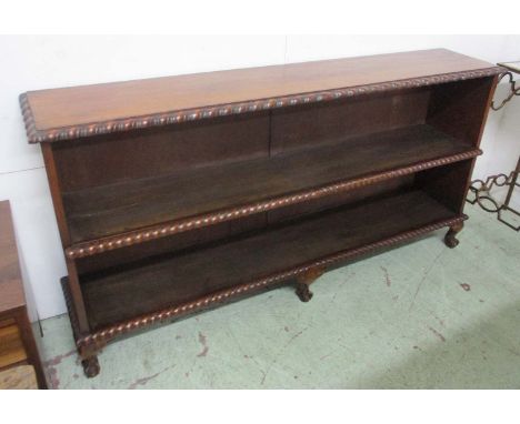 LOW OPEN BOOKCASE, late Victorian walnut with a gadrooned border enclosing a shelf on short cabriole supports with ball and c