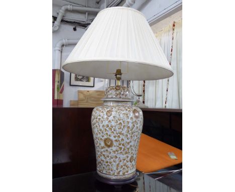 BALUSTER TABLE LAMP, in brown floral glaze on a cream ground, with pleated shade, 54cm H.