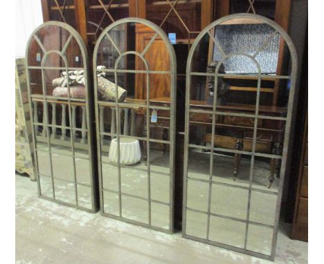 ARCHITECTURAL STYLE GARDEN MIRRORS, a set of three, each verdigris metal framed with an arched top, 66cm W x 159cm H. (3)