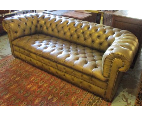 CHESTERFIELD SOFA, with buttoned green leather upholstery, 218cm L x 75cm H. (with faults)