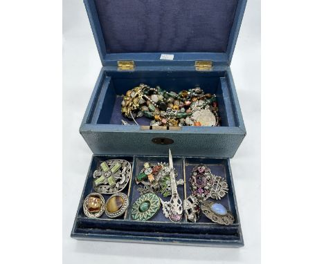 A vintage jewellery box with vintage pieces of jewellery