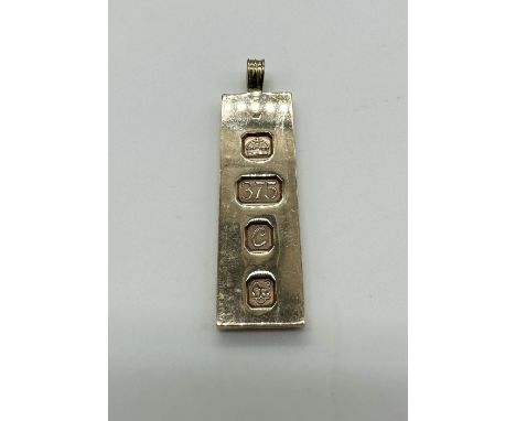 A 9ct yellow gold solid ingot, Size 5cm x 1+1/2cm, approx weight 21.5grams