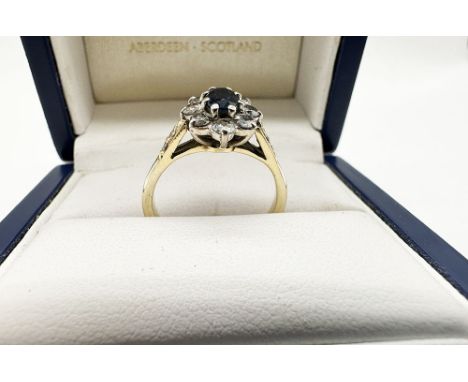 An 18ct yellow gold Diamond + Sapphire daisy style ring, no hallmark, ring has been tested full 18ct diamond sapphire, approx