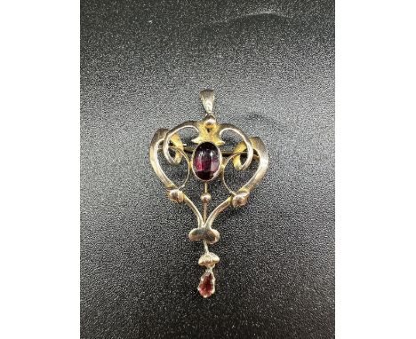 A 9ct yellow gold Victorian pendant / brooch set with garnet centre stone + garnet pear drop stone at the bottom,
approx weig