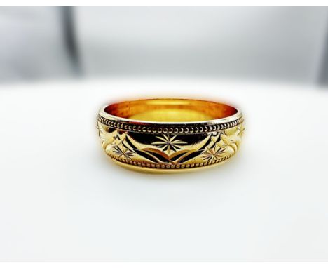 A 9ct yellow gold wedding band millgrain fancy diamond cut design, size M+1/2, width 5mm, approx weight 3.1 grams