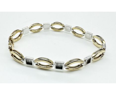 A 9ct yellow + white gold bracelet, 7 + 1/2 inches in length, hallmarked, approx weight 11.5 grams