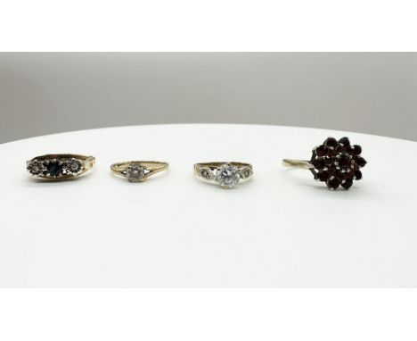 A selection of 4 9ct yellow gold rings,
garnet ring is size O + 1/2,
small cz stone ring&nbsp; is size J,
sapphire stones rin