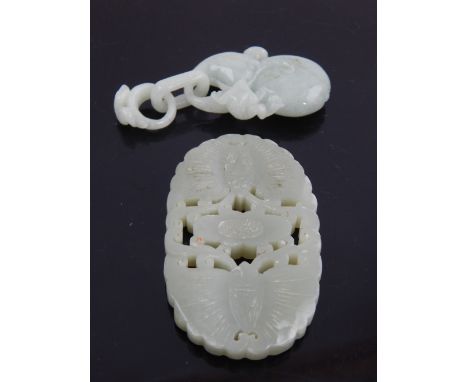 Chinese green hardstone pendant of naturalistic form and a pierced oval jade plaque.