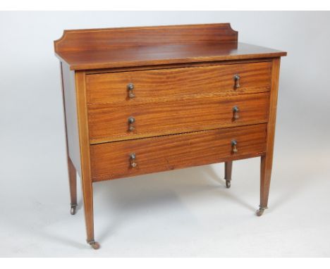 Edwardian mahogany chest of drawers, satinwood chequer and line inlay, brass drop handles, tapering box legs, ceramic castors