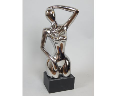 Contemporary silvered ceramic sculpture, female nude on rectangular ebonised plinth, 75cm H.