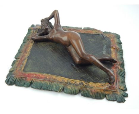 Austrian style cold painted bronze, modelled in the form of a woman reclining on a Persian rug, 19cm w.