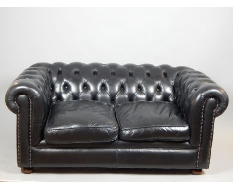 Black Chesterfield, traditional button back leather sofa, gunmetal tacks, bun feet, approx. 153cm w.