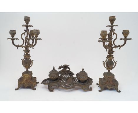 A brass Rococo styled double inkwell, late 19th / early 20th century, the stand surmounted with a crouching dragon, 29cm long