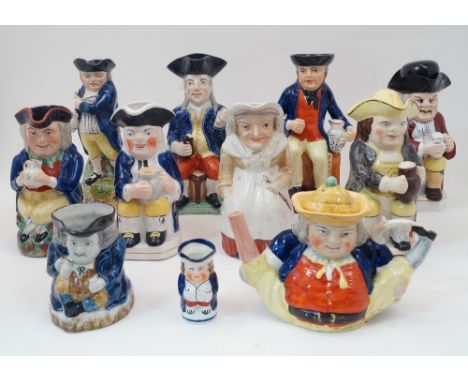 A group of Staffordshire Toby jugs, 19th century and later, to include a gentleman in blue jacket with a pipe and mug of ale,