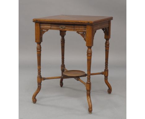 A Victorian Aesthetic mahogany envelope card table, with single drawer, raised on turned reeded supports and scroll feet, joi