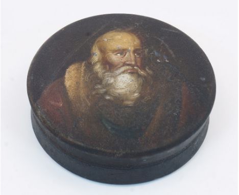 A Stobwasser type papier-mache snuff box, 19th century, of circular form, the pull-off top painted with a portrait of a beard