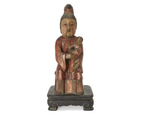 A Chinese carved and parcel-gilded wood figure of a mother and child, 20th century, modelled seated on a chair, her robes pai