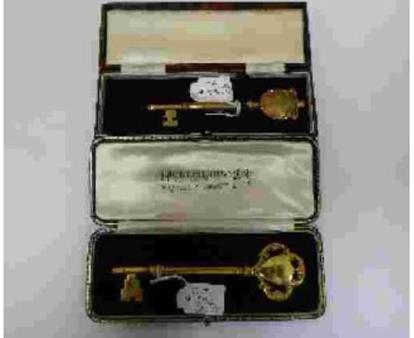 A silver-gilt presentation key, London, 1936, Hicklenton & Phillips, 11.5cm, surmounted with shield and c-scrolls, the obvers
