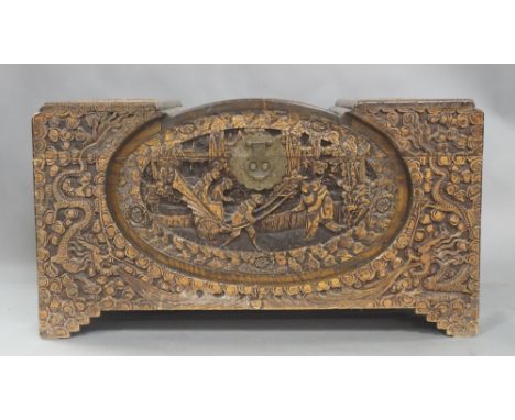 A Chinese camphor chest, 20th century, carved with scenes of Chinese junks, figures and dragons, with square cut bracket feet