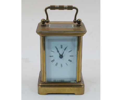 A Swiss miniature brass carriage timepiece, early 20th century, with bevelled glass panels and white enamel dial with Roman n