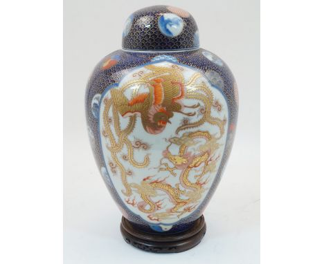 A Japanese Fukagawa Seiji baluster jar and cover, c.1900-1920, with overall fish scale ground in cobalt blue and three decora