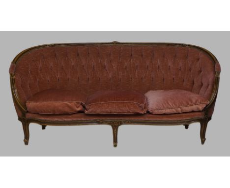 A French mahogany sofa, 20th century, with pink button back velour upholstery, raised on cabriole legs, together with a pair 