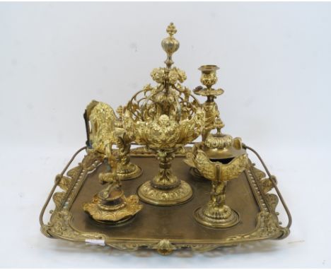 A Continental gilt metal table or desk-top centrepiece, 19th century, the tray with rococo style border and rail supporting f