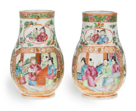 A pair of Chinese Canton famille rose porcelain vases, 19th century, each of pear shape form with a short foot rising to a wi