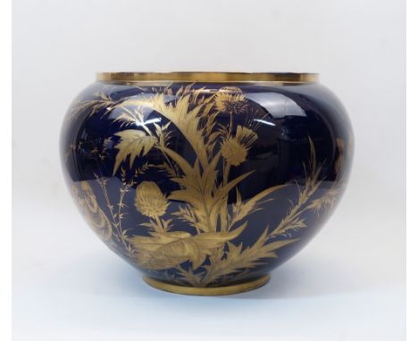 A large ceramic cobalt blue jardiniere, 20th century, the exterior gilt-heightened with two partridges and various flora, ins
