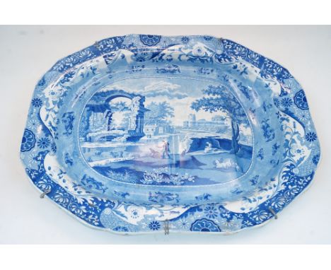 A large Victorian Spode blue and white meat plate, with transfer printed scene of a European Classical landscape, with foliat