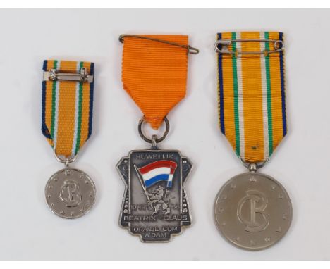 A base metal medal commemorating the marriage of Princess Beatrix of the Netherlands to Claus van Amsberg; together with two 
