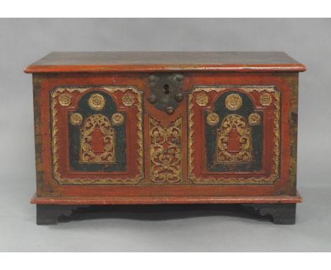 An Indian painted teak trunk, early 20th century, the front with floral carvings, the hinged lid enclosing candle box, raised