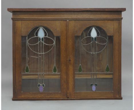 Art Nouveau oak and glazed wall mounted bookcase, early 20th Century, formerly the top section to a larger bookcase, the lead