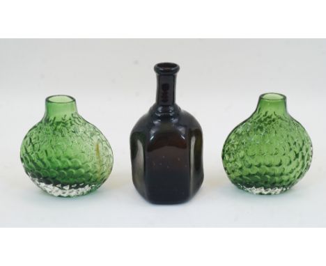 A pair of moulded green glass ‘fish scale’ vases, 20th century, 14cm high; together with a blown hexagonal glass bottle, 18cm