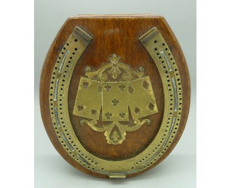 An oak and brass horseshoe shaped cribbage board with drawer