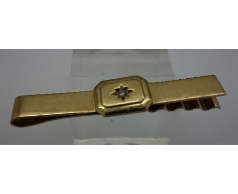 A 9ct gold tie pin set with a diamond, weight 8.3g